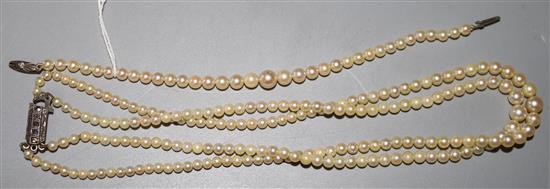 A single strand cultured pearl necklace and similar bracelet.